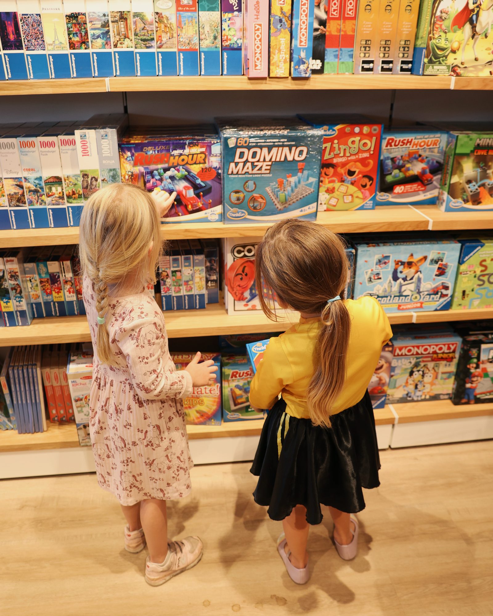 Two children browsing the games wall at Wonderloft